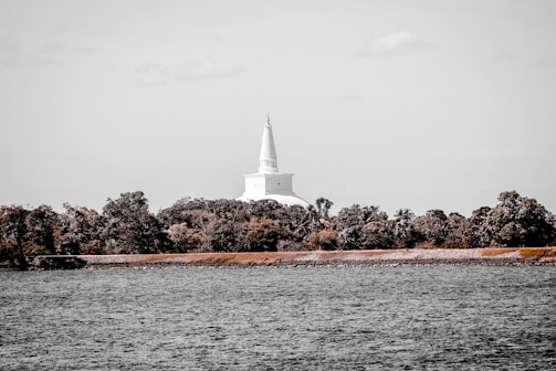 A serene temple surrounded by lush greenery and trees.