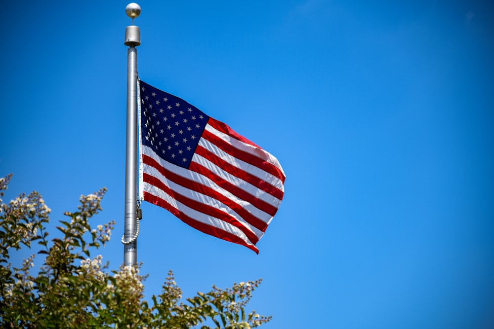 us a flag on pole during daytime