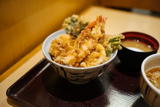 brown rice on white and blue ceramic bowl