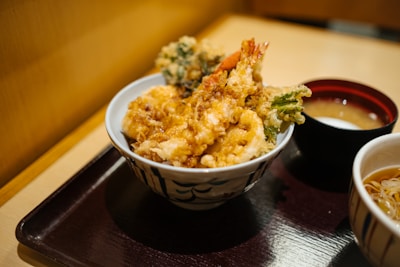 brown rice on white and blue ceramic bowl