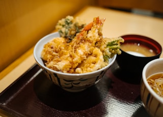 brown rice on white and blue ceramic bowl