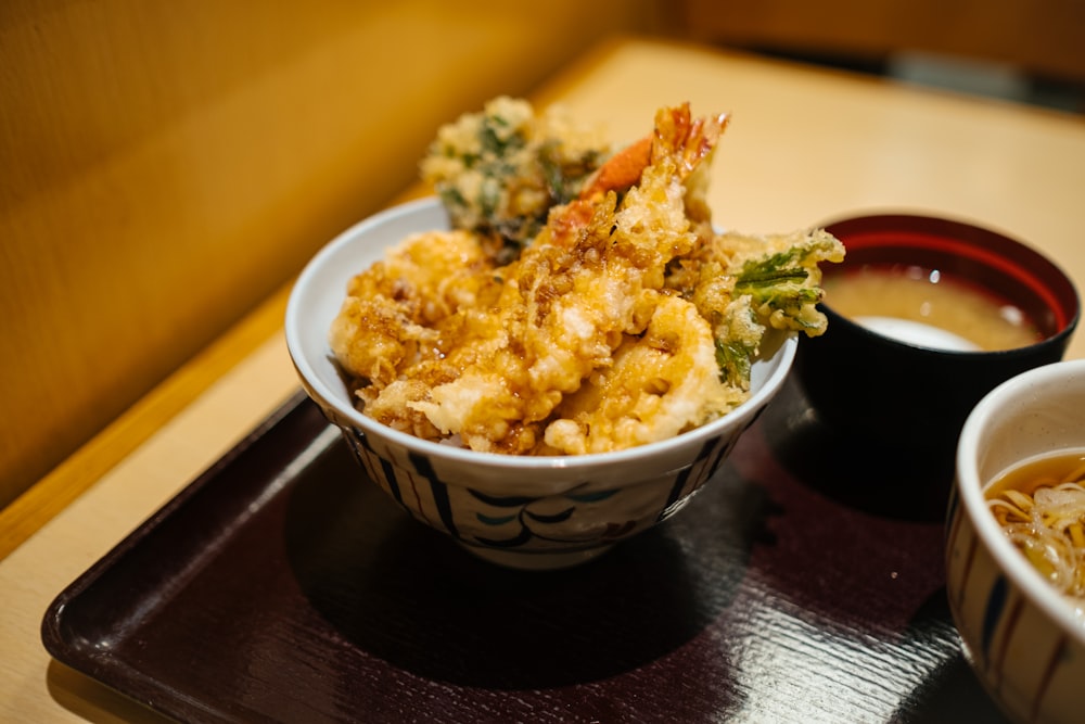 brown rice on white and blue ceramic bowl