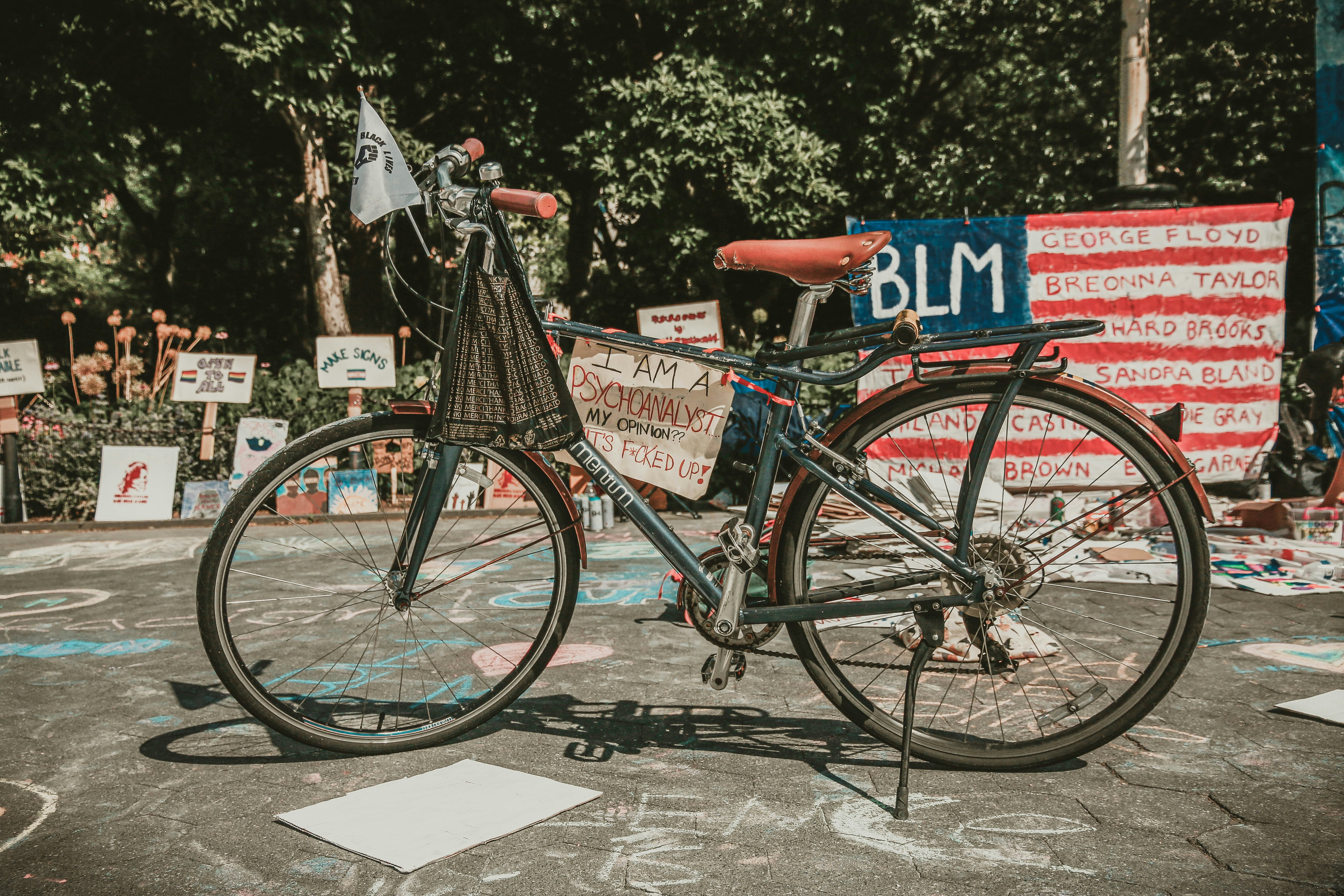 red and black city bike parked beside red and white stop sign