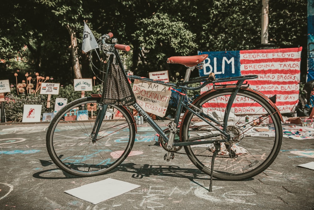 red and black city bike parked beside red and white stop sign