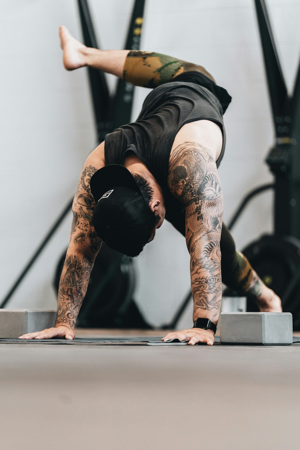 man in black tank top and black shorts doing exercise