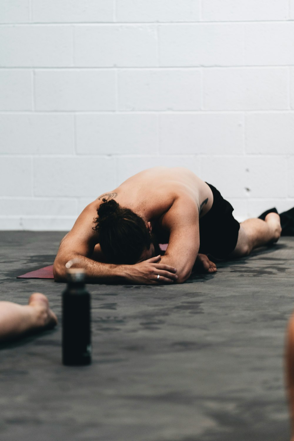 woman in black tank top lying on floor