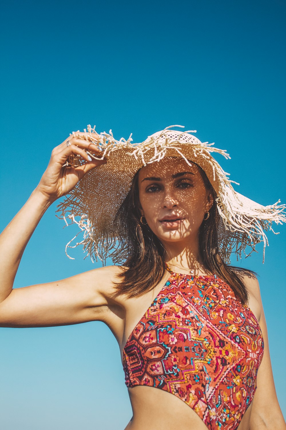 woman in red and blue floral tube top