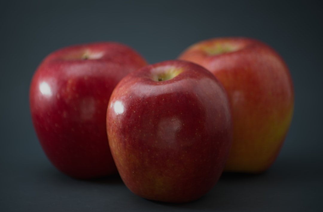 red apple fruit on black table