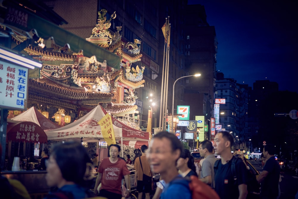 people walking on street during night time