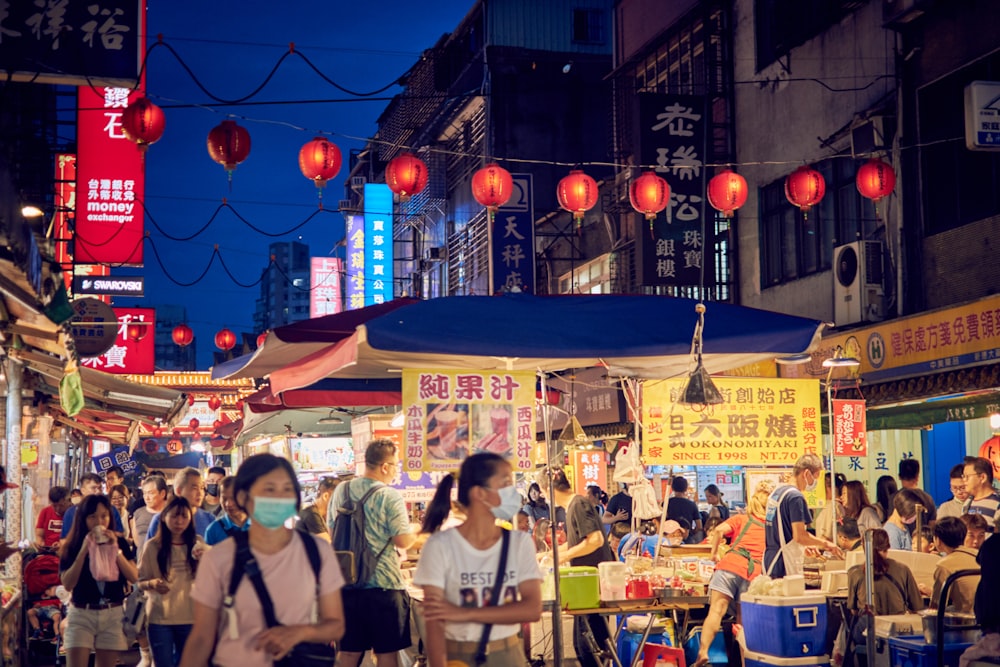 people walking on street during night time