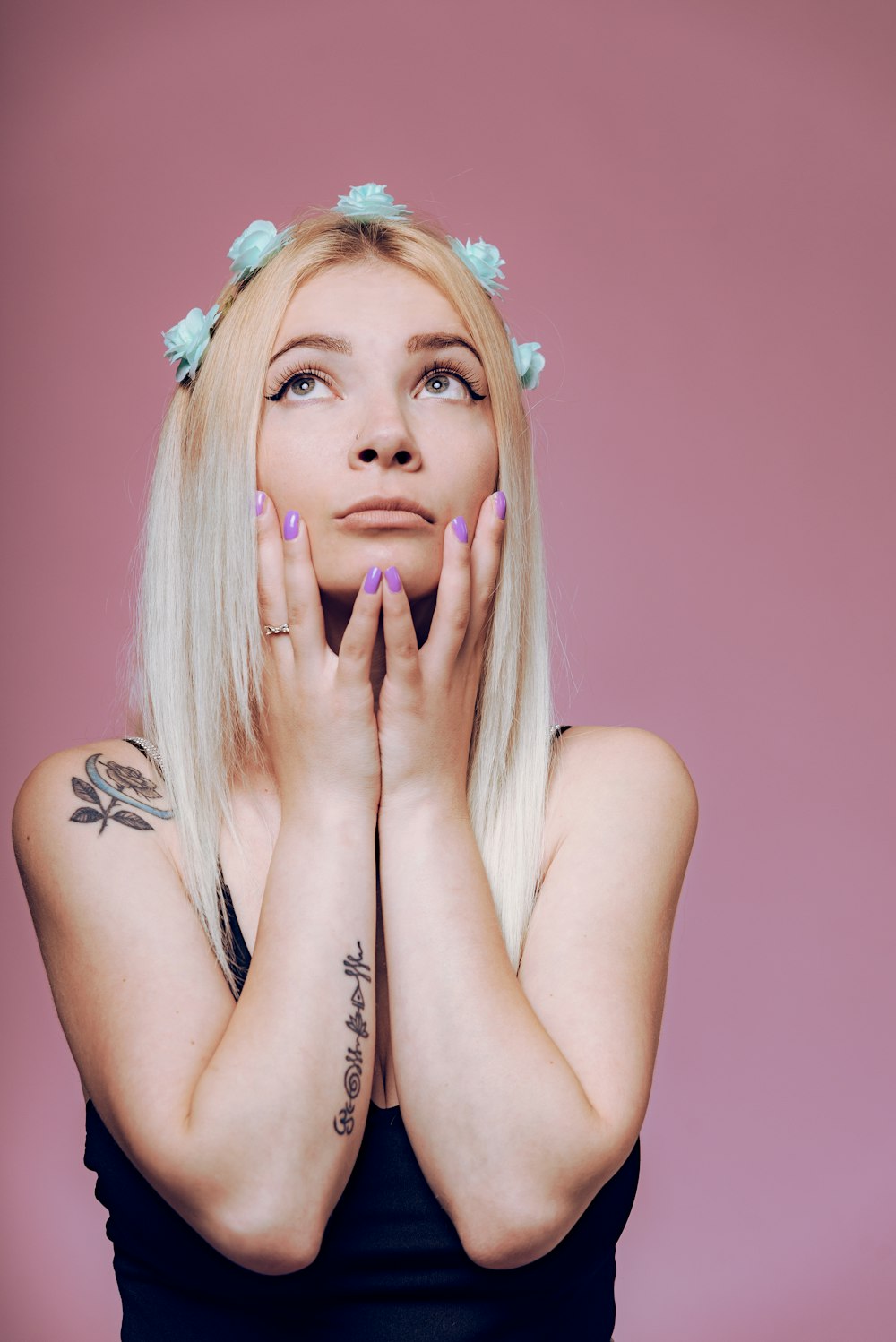 woman with blonde hair wearing white floral headband