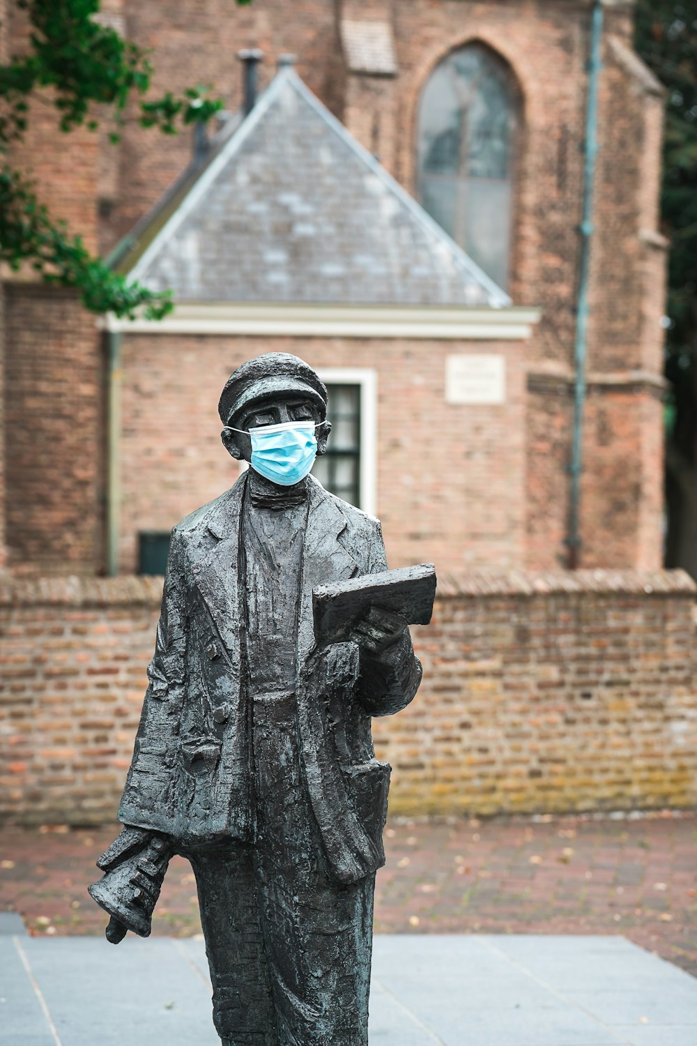 man in black coat statue