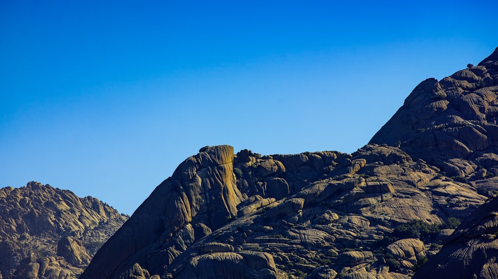 person standing on rock formation during daytime