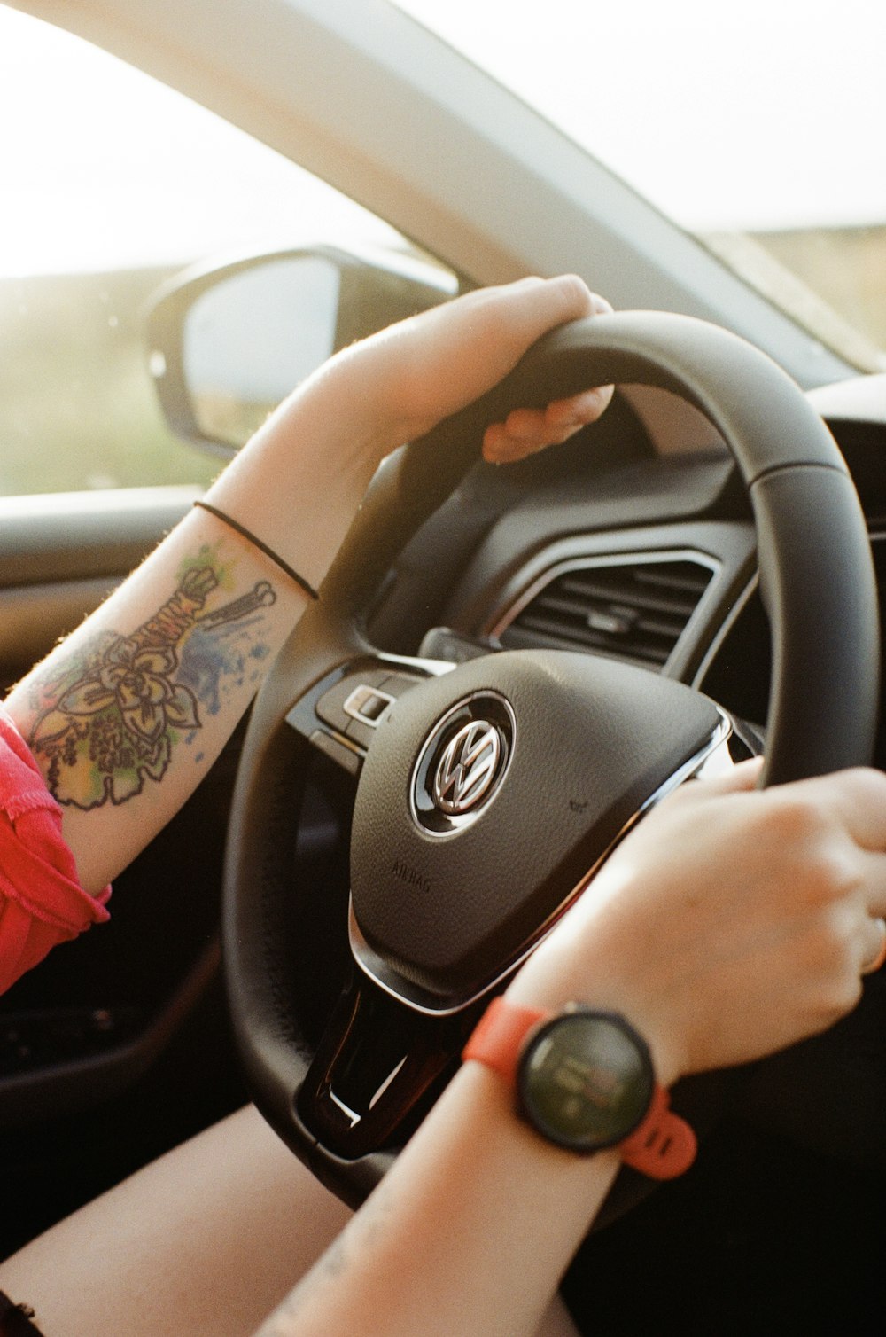 person holding black and gray bmw steering wheel