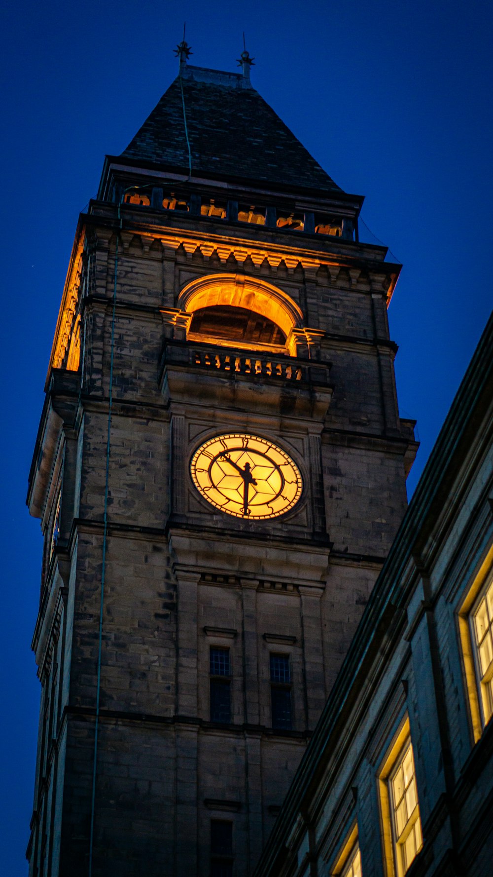 brown concrete building with analog clock