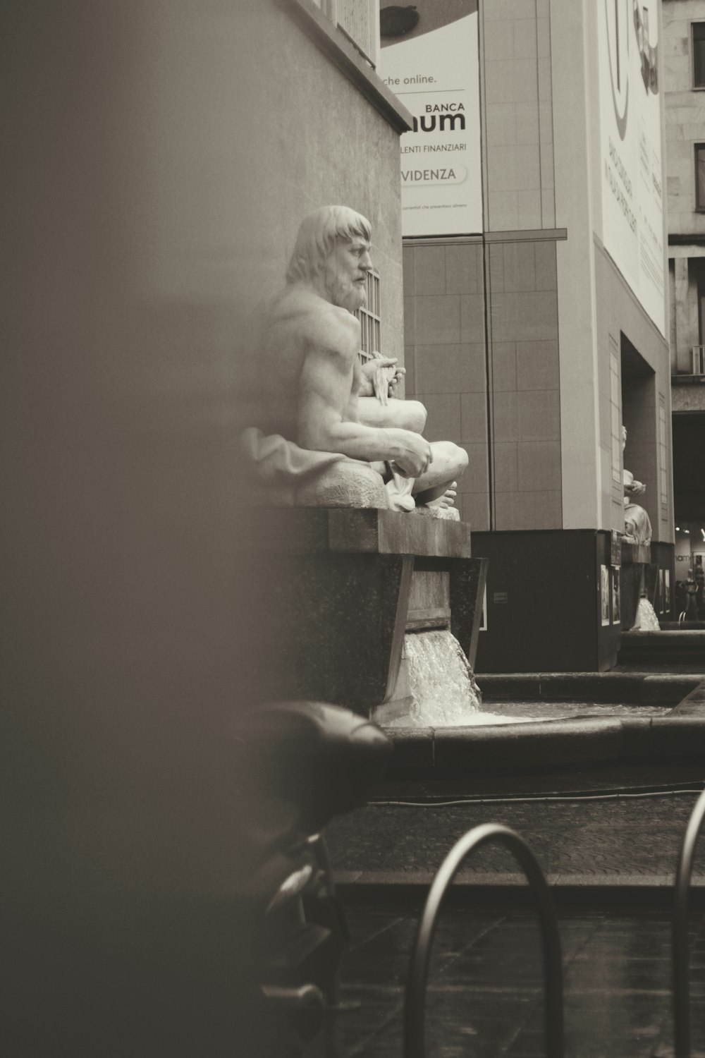 grayscale photo of woman sitting on chair