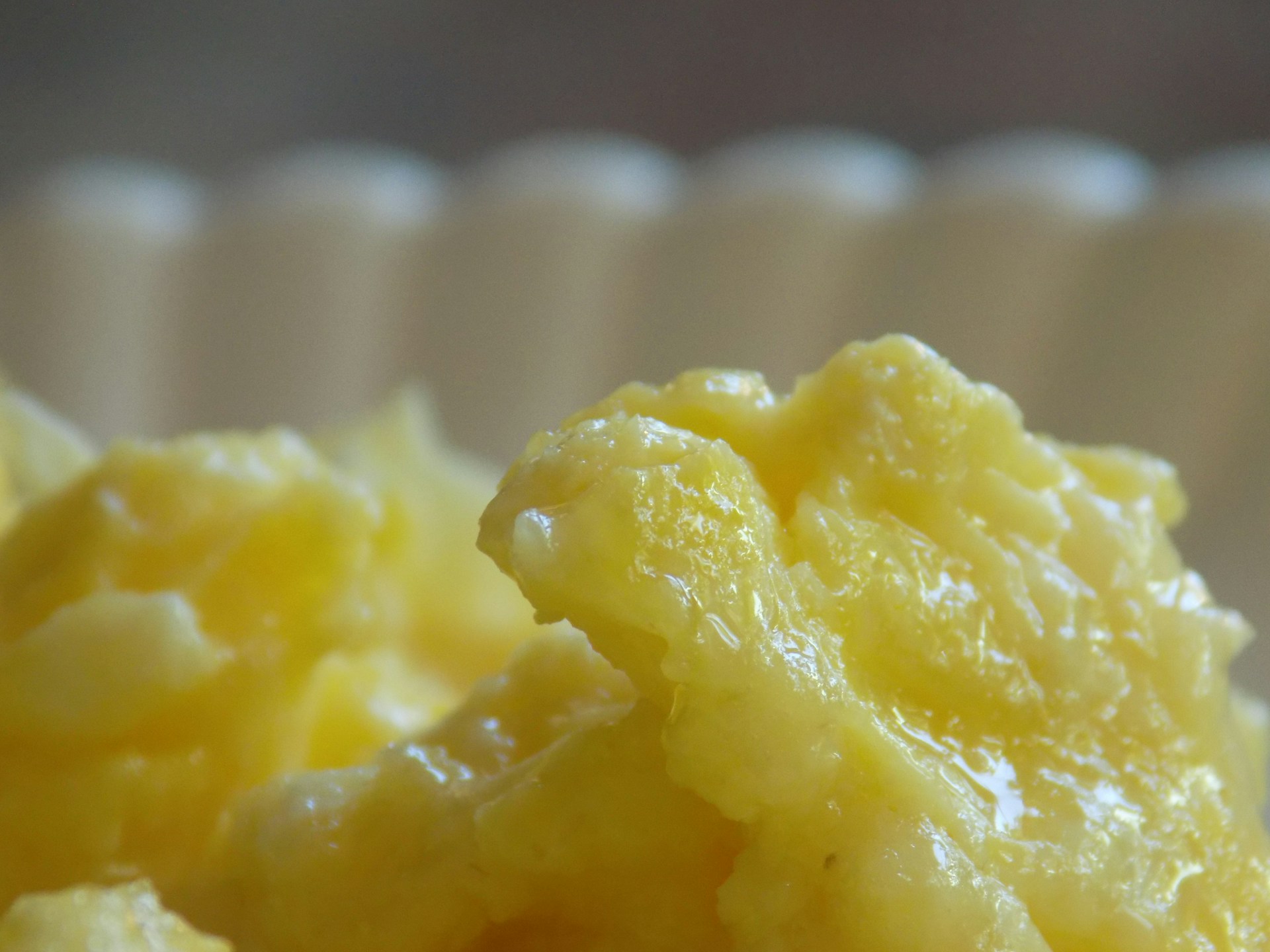 Close-up of scrambled eggs with a soft, creamy texture, displaying a rich yellow color.