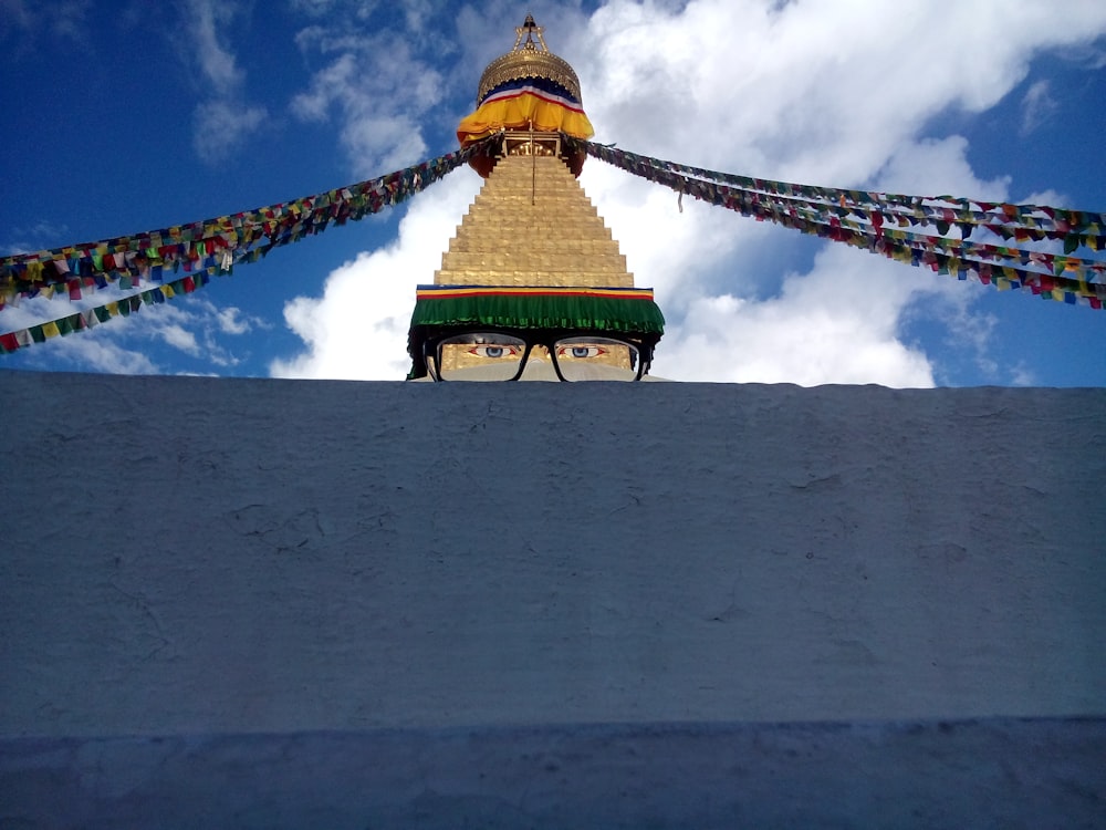 yellow green and red temple on white wall