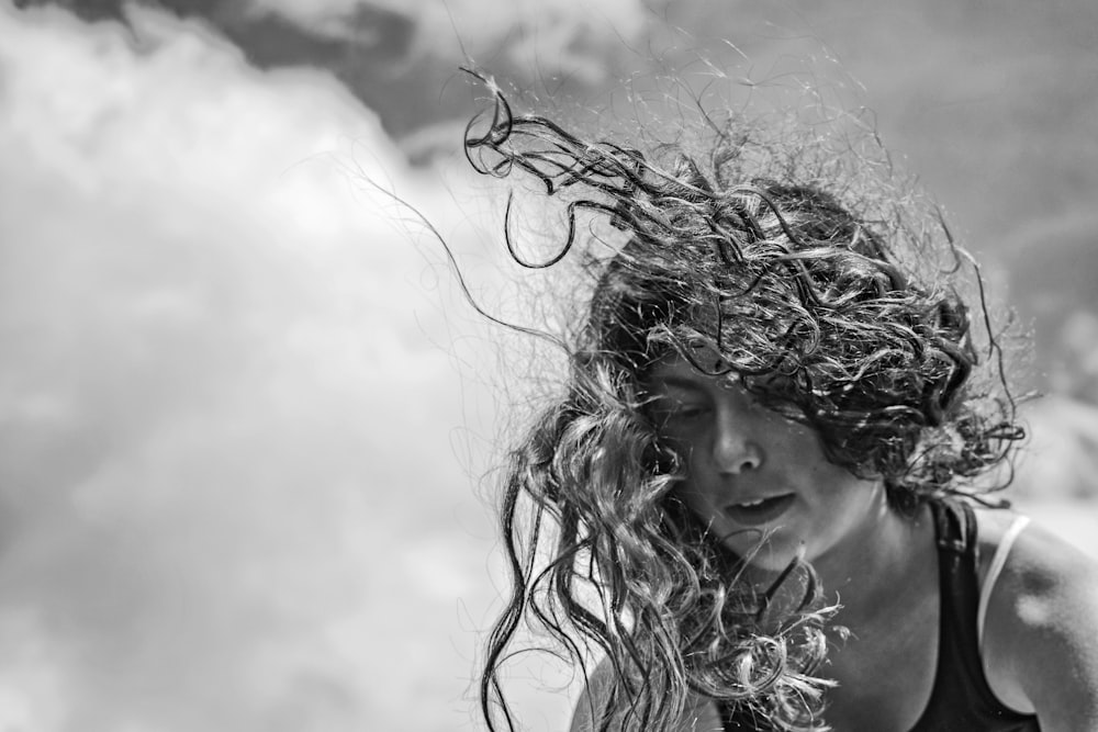 grayscale photo of woman with curly hair