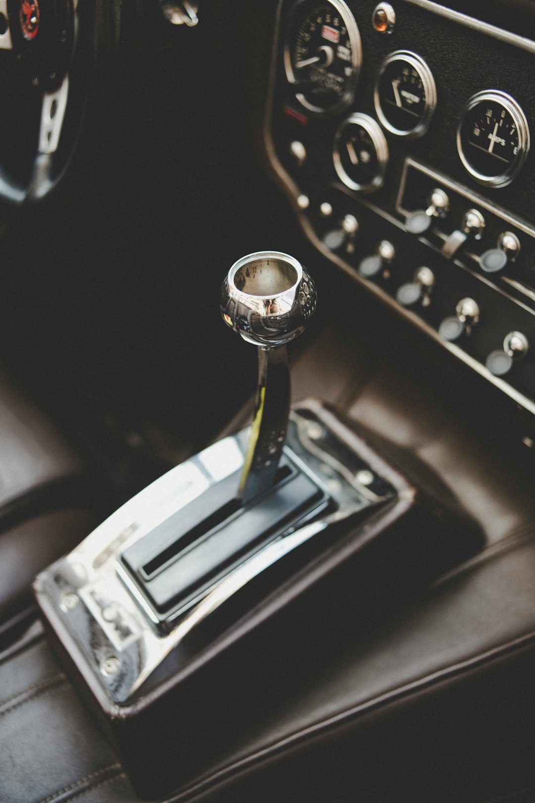 gold and silver car gear shift lever