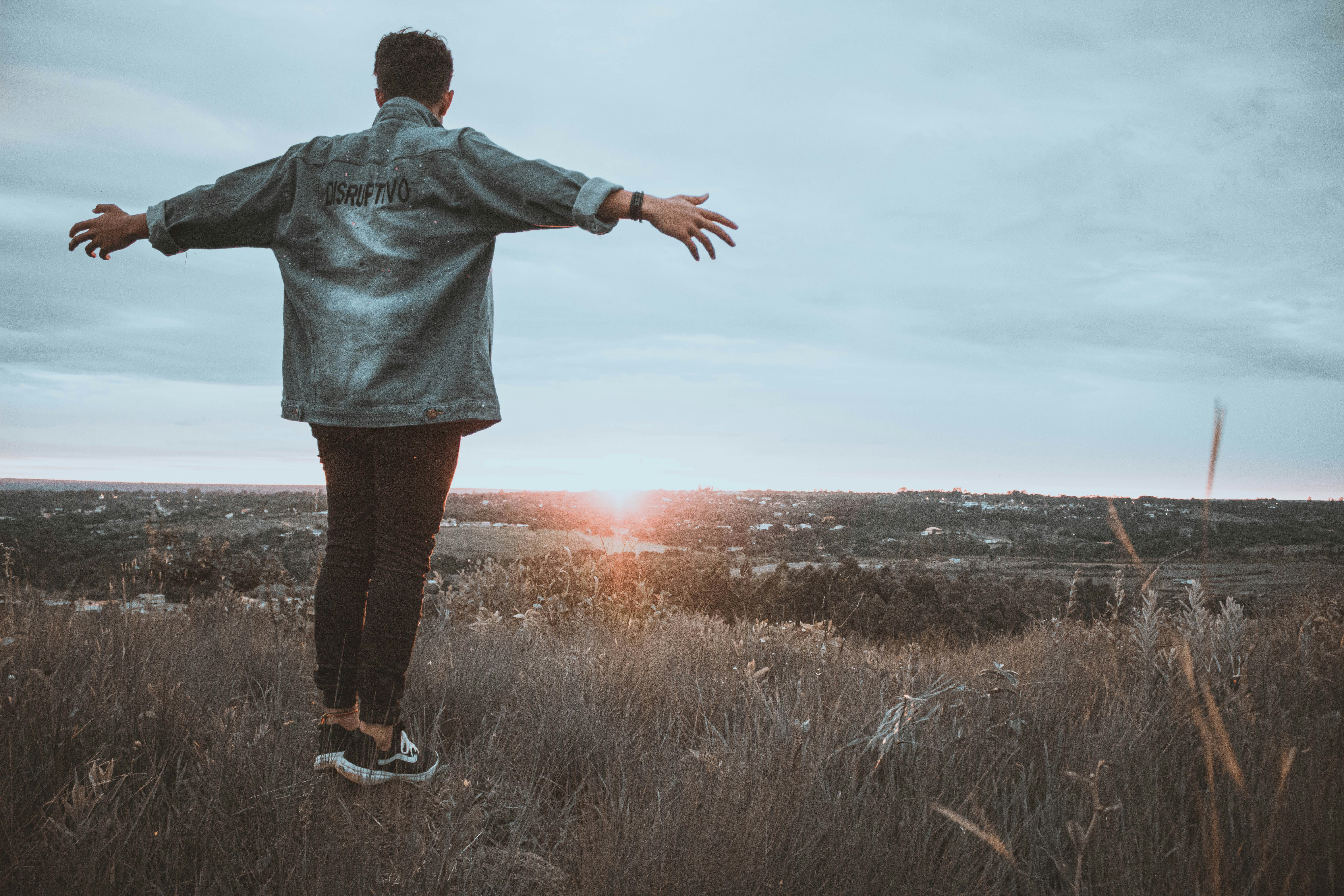 woman wearing yellow long-sleeved dress under white clouds and blue sky during daytime
