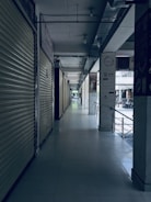 white tiled hallway with white metal doors