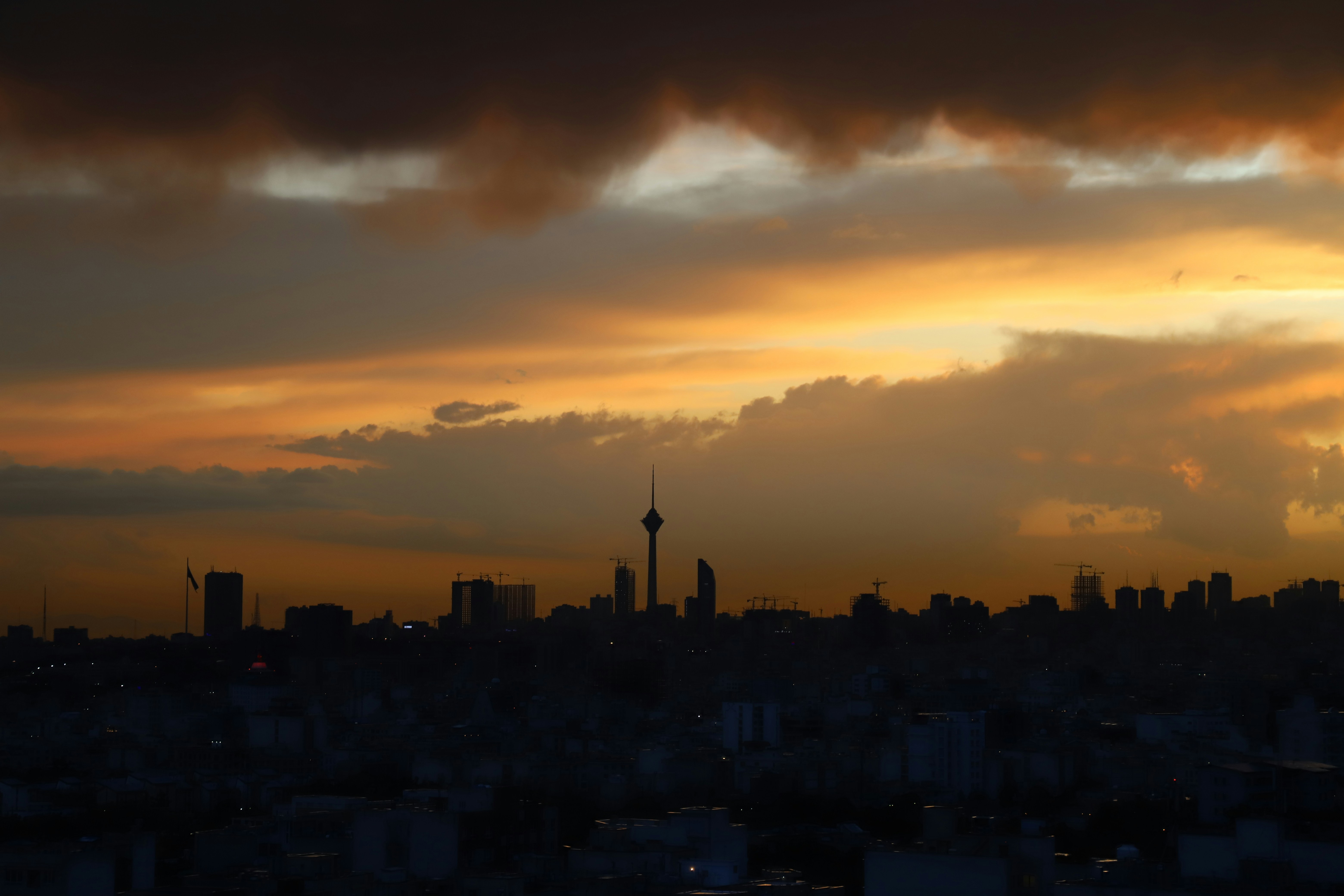 city skyline under blue and white cloudy sky during daytime