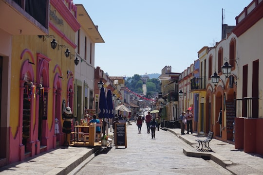 people walking on street near buildings during daytime in San Cristobal de las Casas Mexico