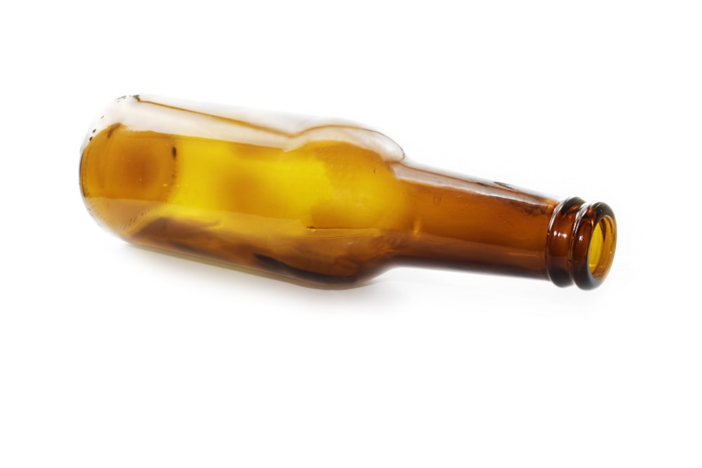 brown glass bottle with white background