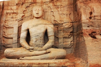 brown concrete statue of a woman
