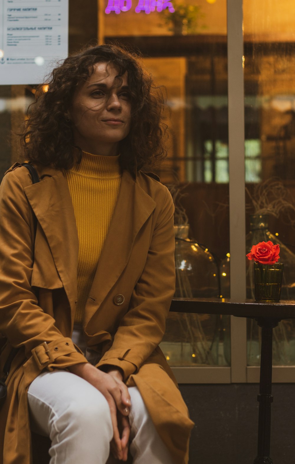 woman in brown coat sitting on chair