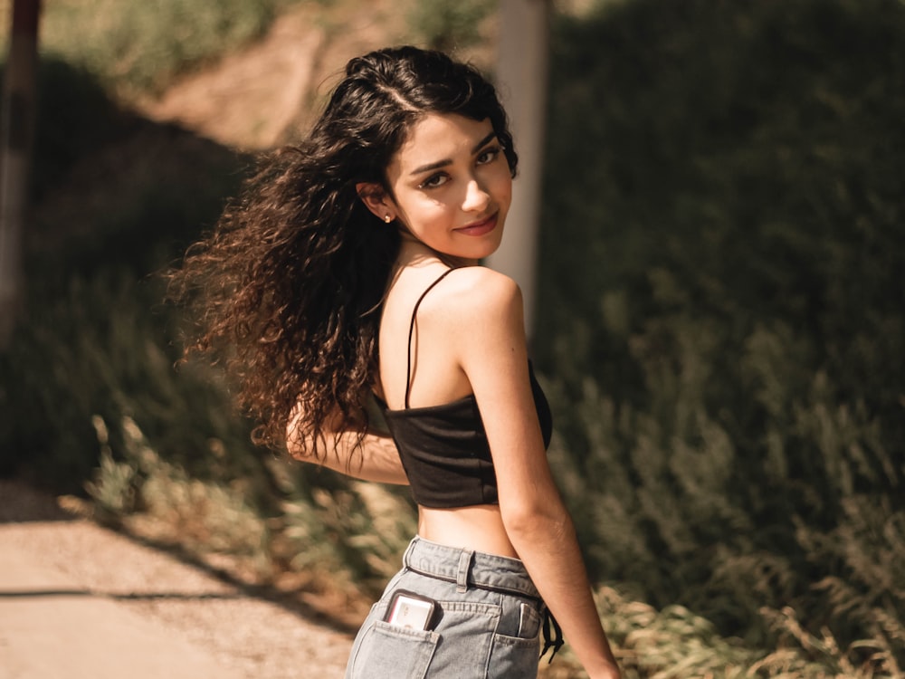 woman in black tank top and blue denim shorts