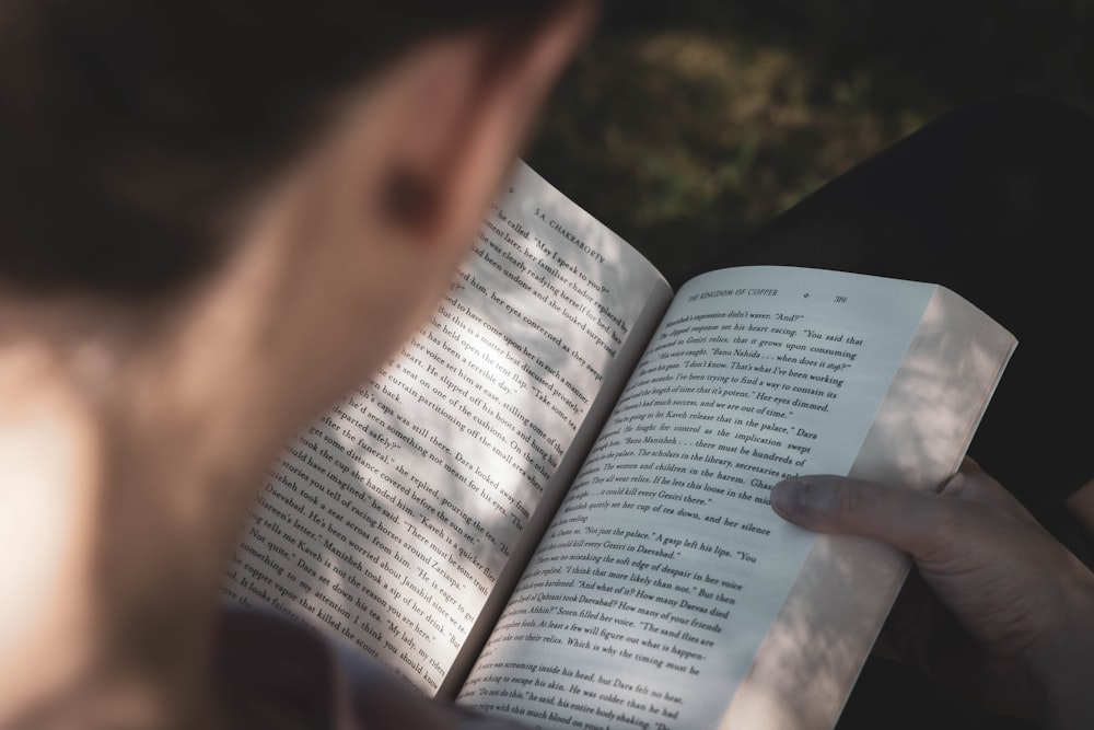 person holding white printer paper