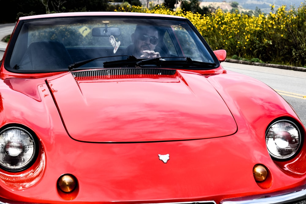 red ferrari car on road during daytime