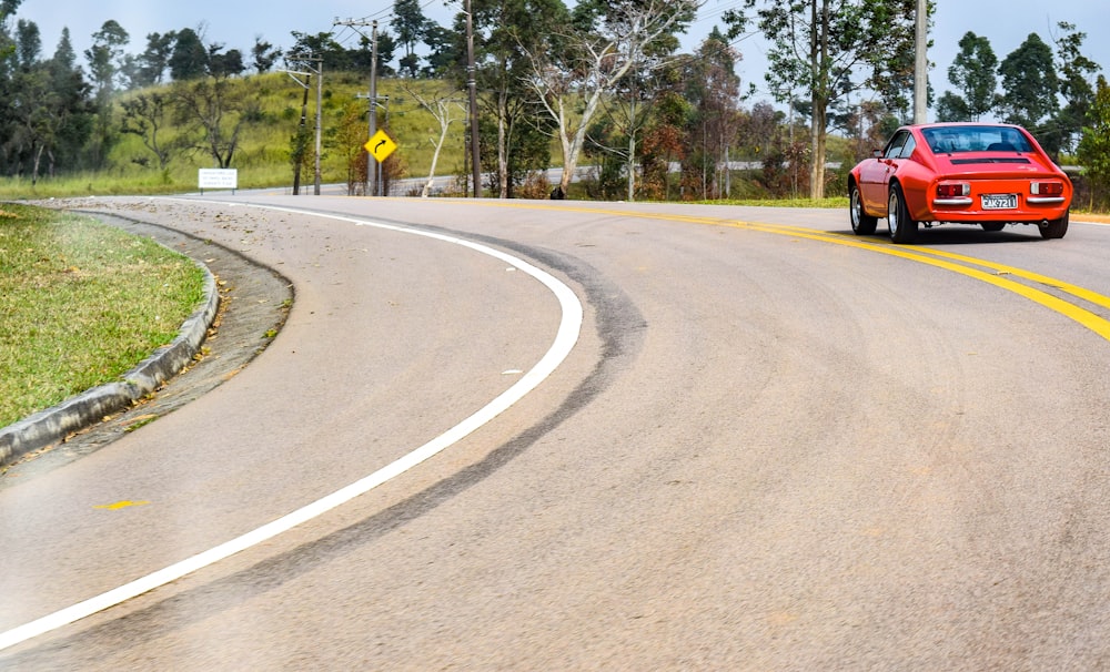 red car on road during daytime