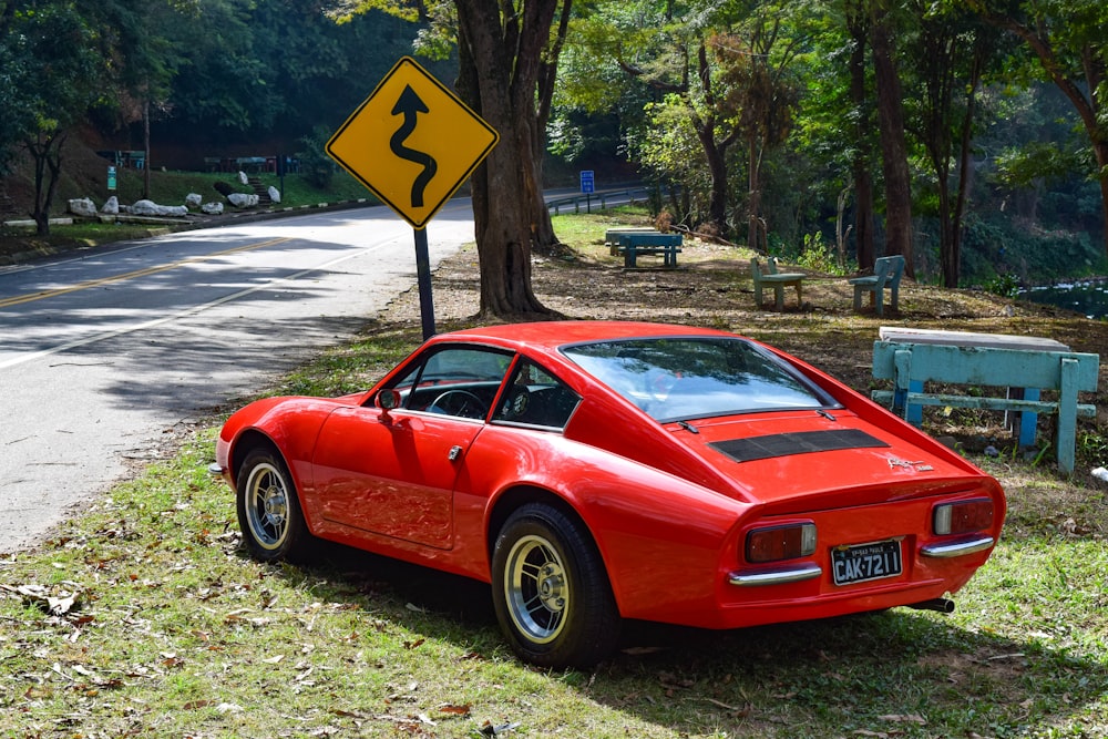 red ferrari 458 italia parked on gray asphalt road during daytime