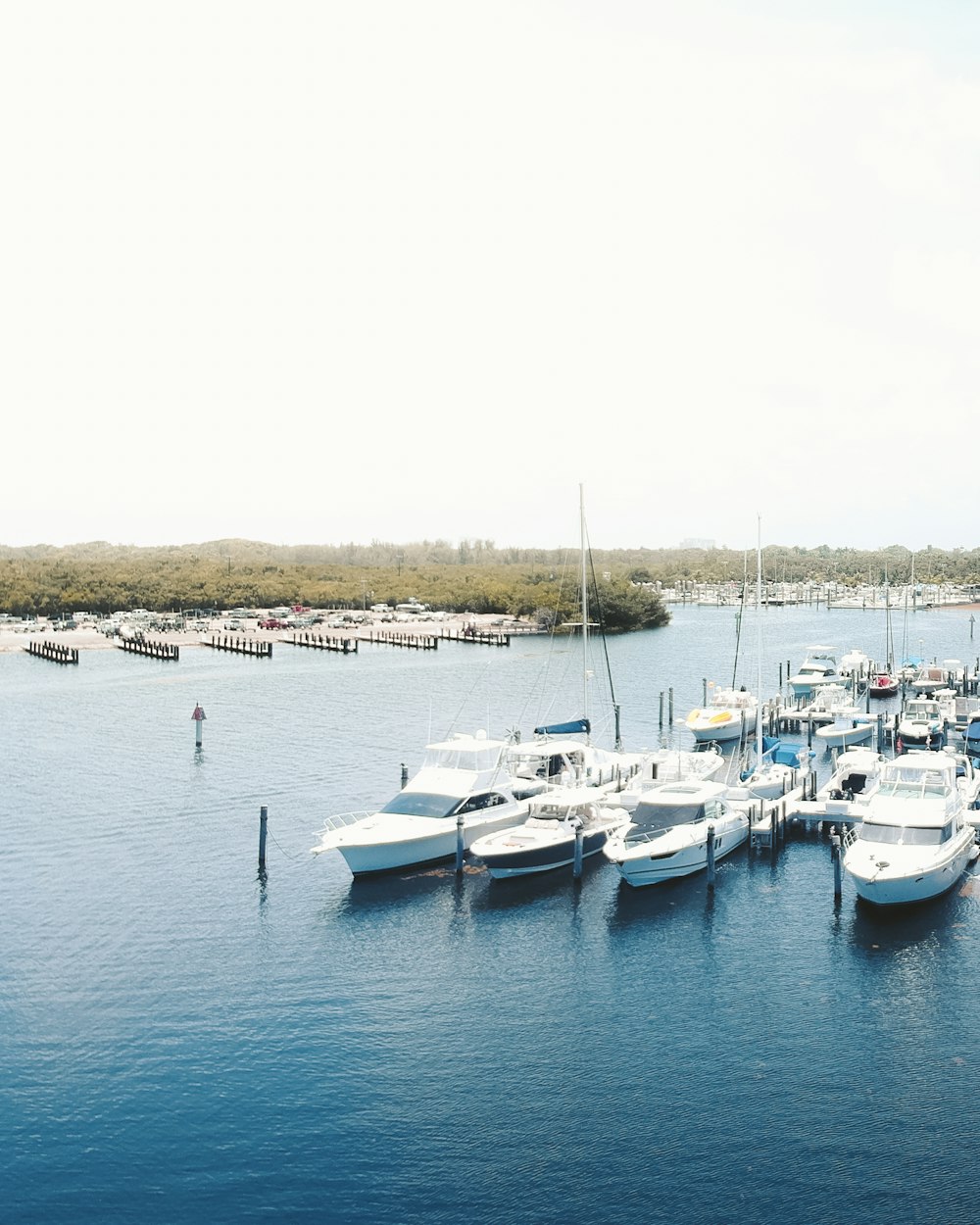 white and blue boats on sea during daytime