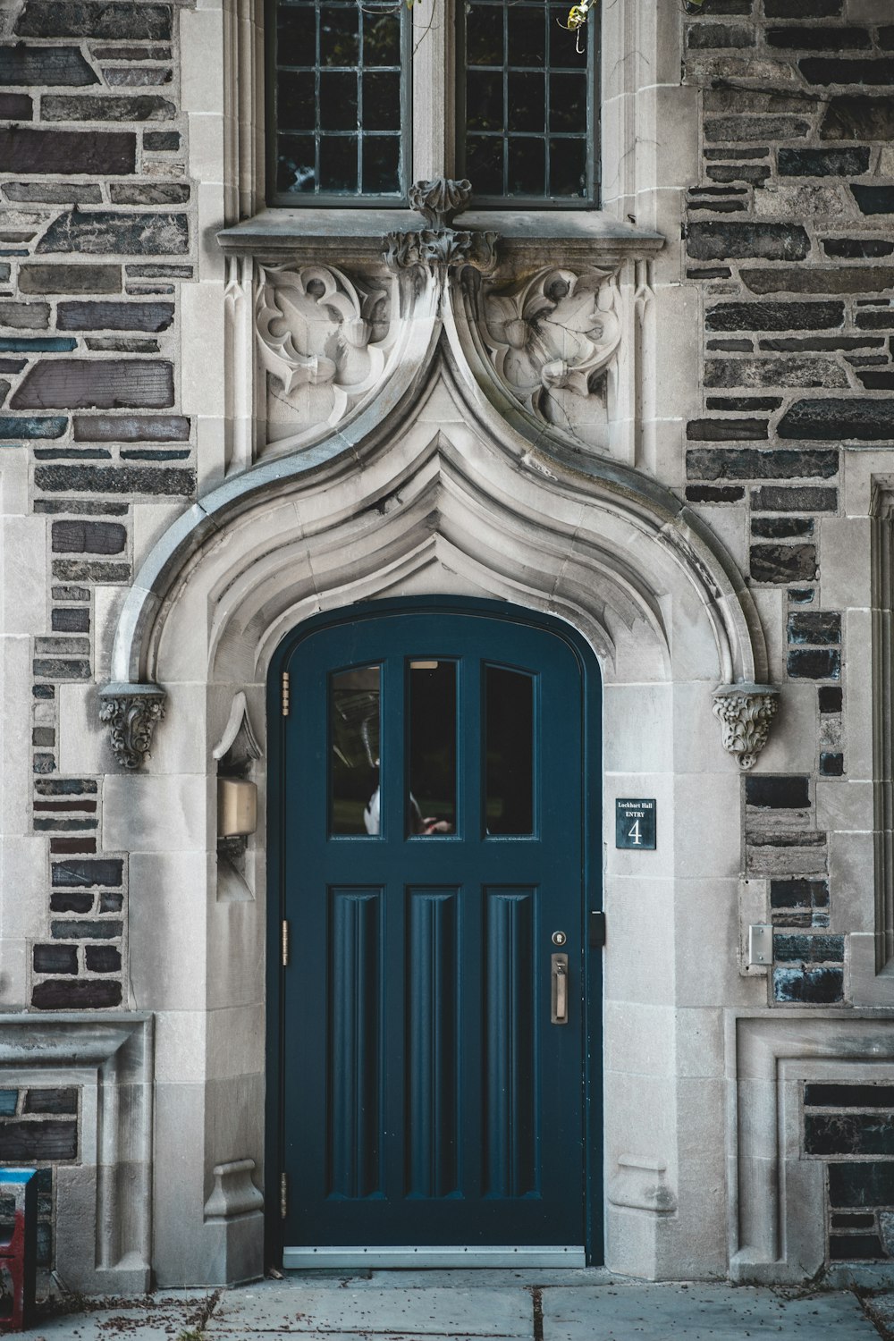 blue wooden door on brown brick wall