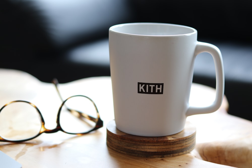 white ceramic mug on brown wooden coaster