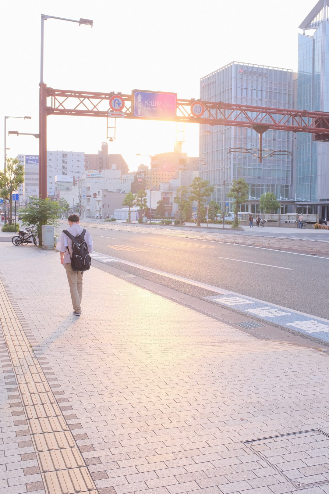 man in black jacket walking on sidewalk during daytime