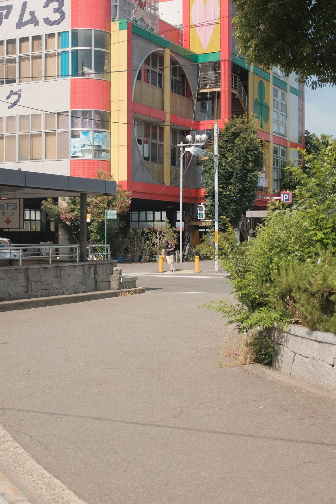 green plants in front of red and white concrete building