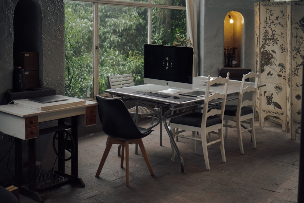 black flat screen computer monitor on brown wooden table