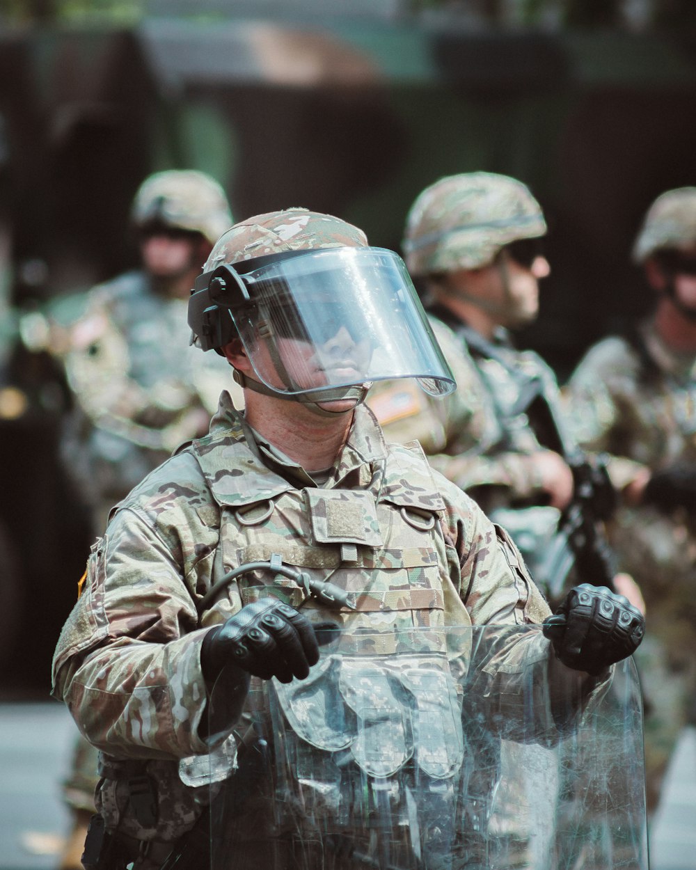 man in brown and black camouflage uniform wearing helmet