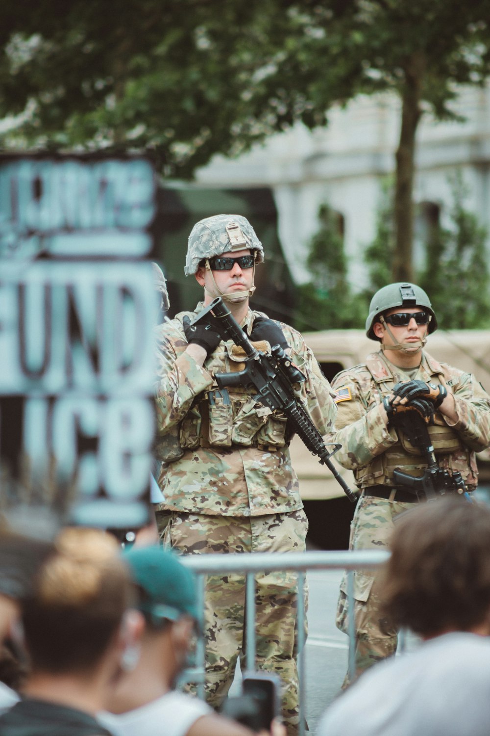 Hombre con uniforme de camuflaje marrón y negro sosteniendo un rifle