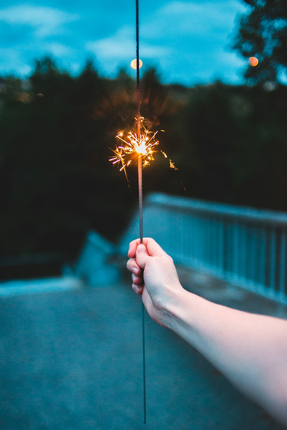 person holding sparkler during daytime