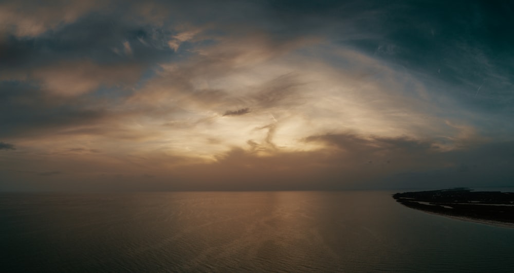 body of water under cloudy sky during daytime