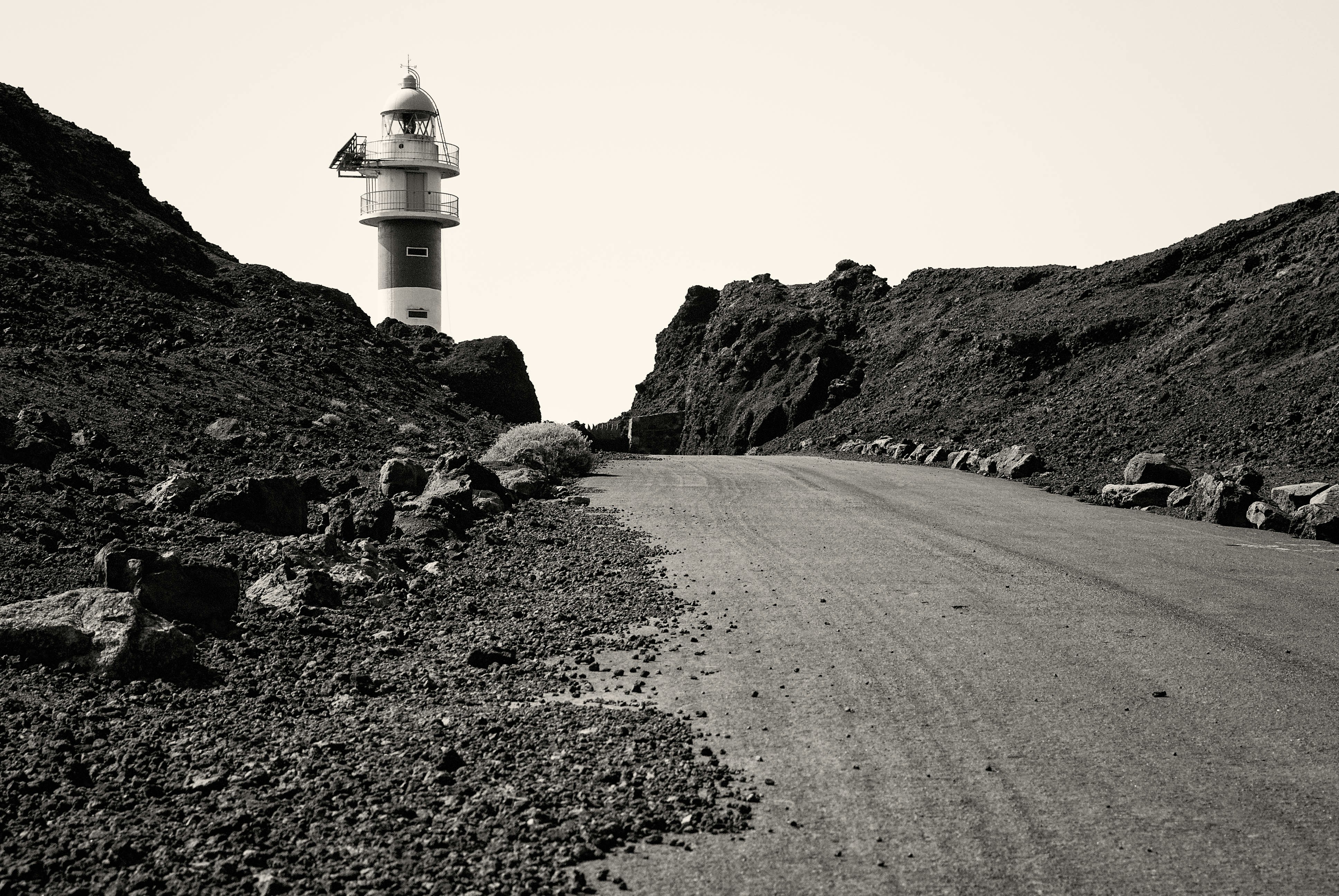 white lighthouse on brown hill during daytime