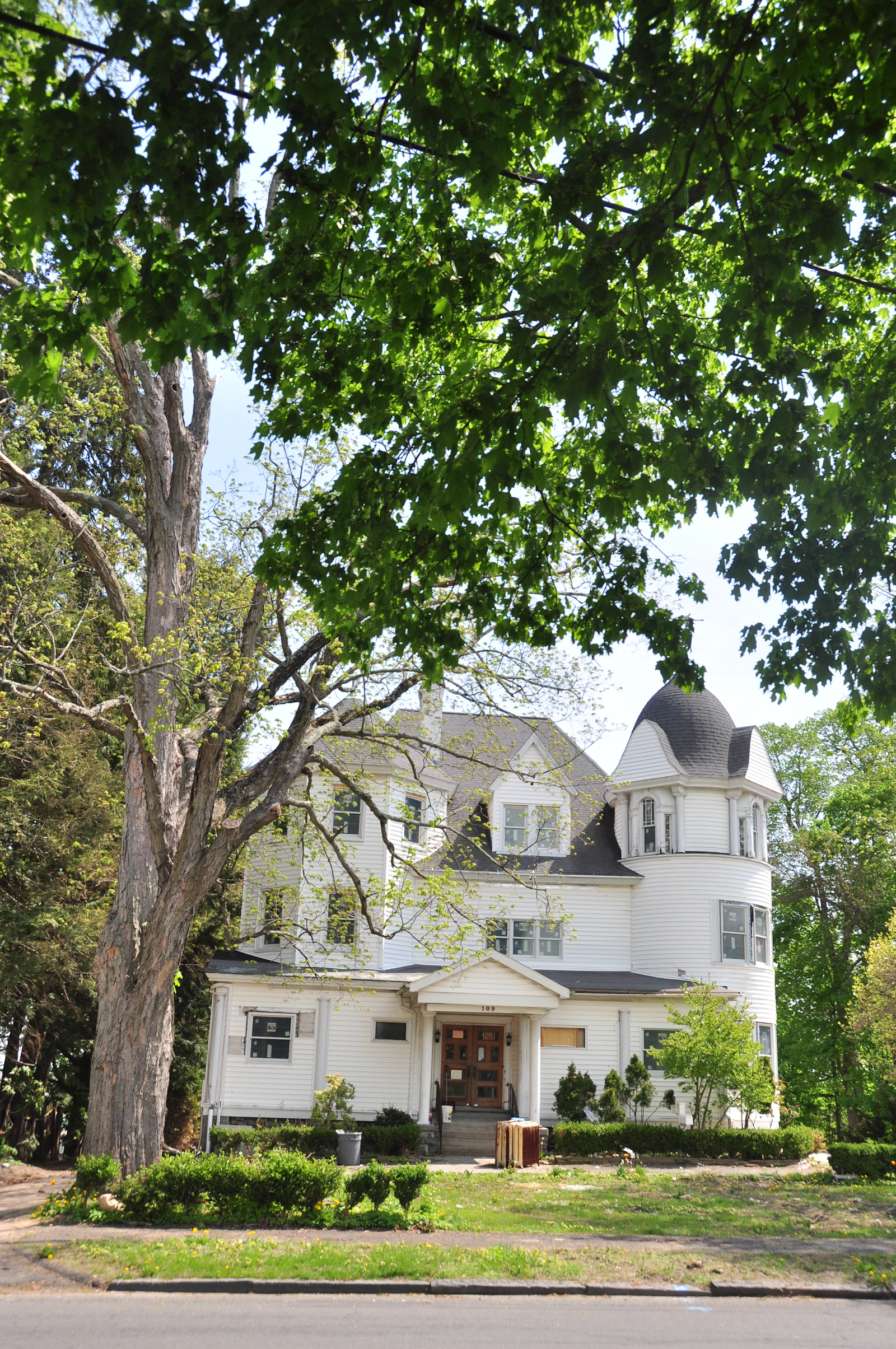 White clapboard farmhouse in full summer sun, the kind of listing that sells in a weekend