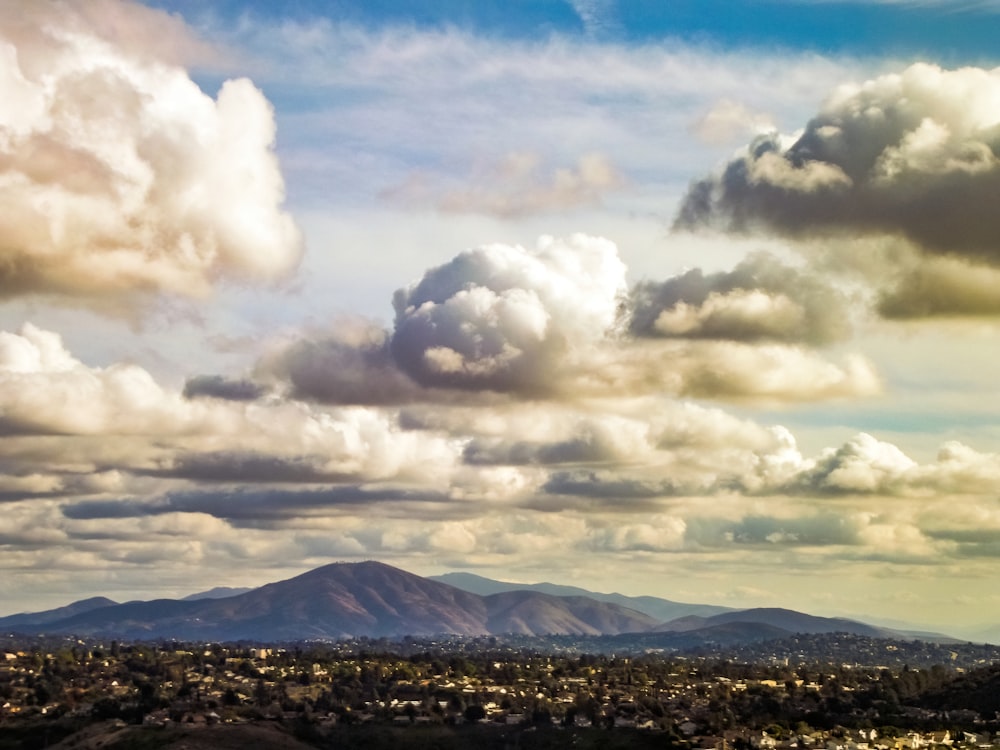 white clouds over mountains and mountains