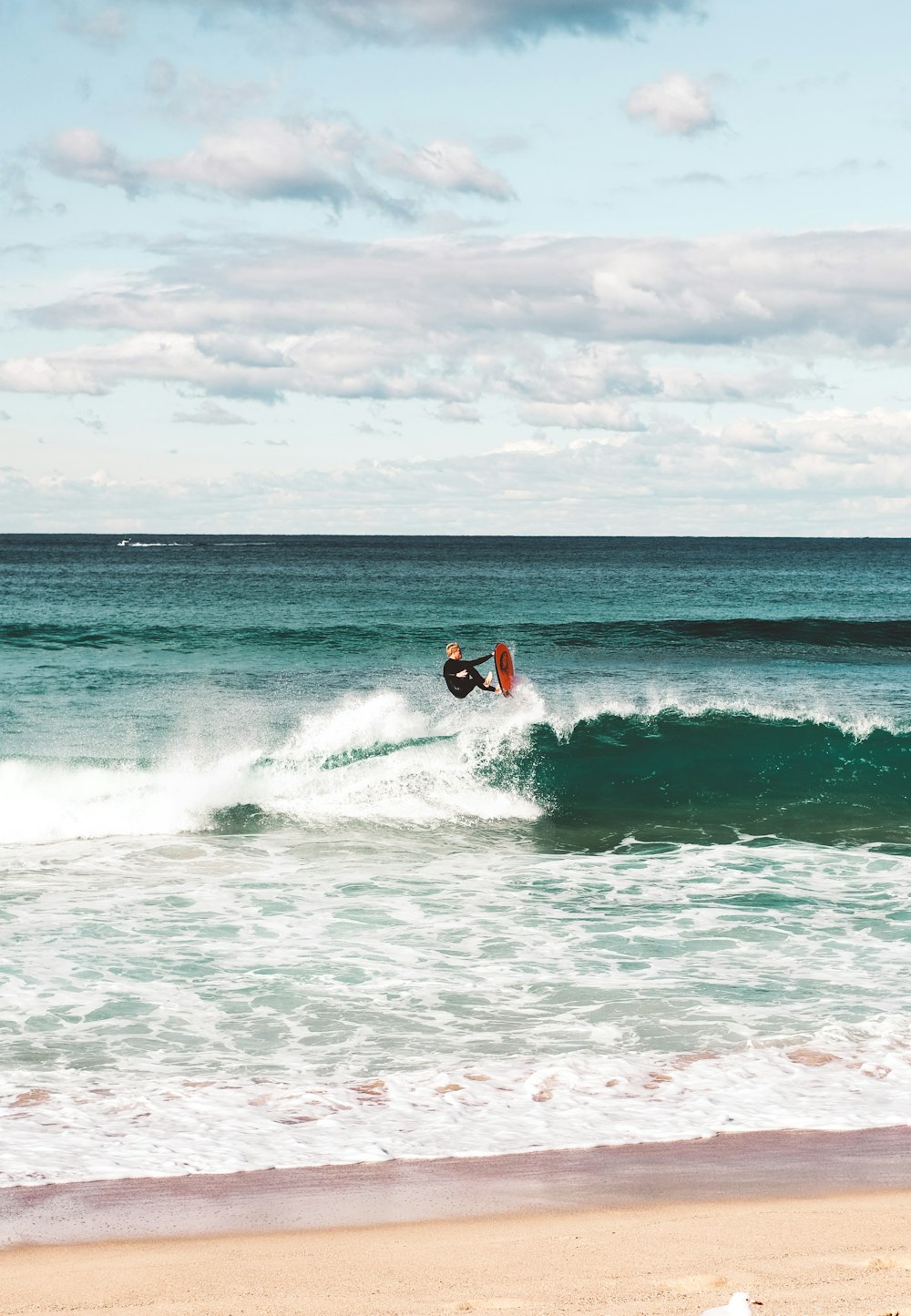 man surfing on sea waves during daytime